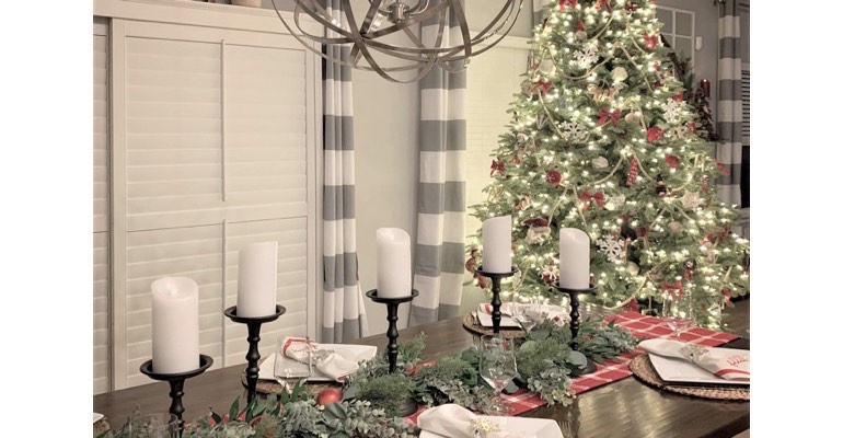 Holiday table with candles in festive dining room. 